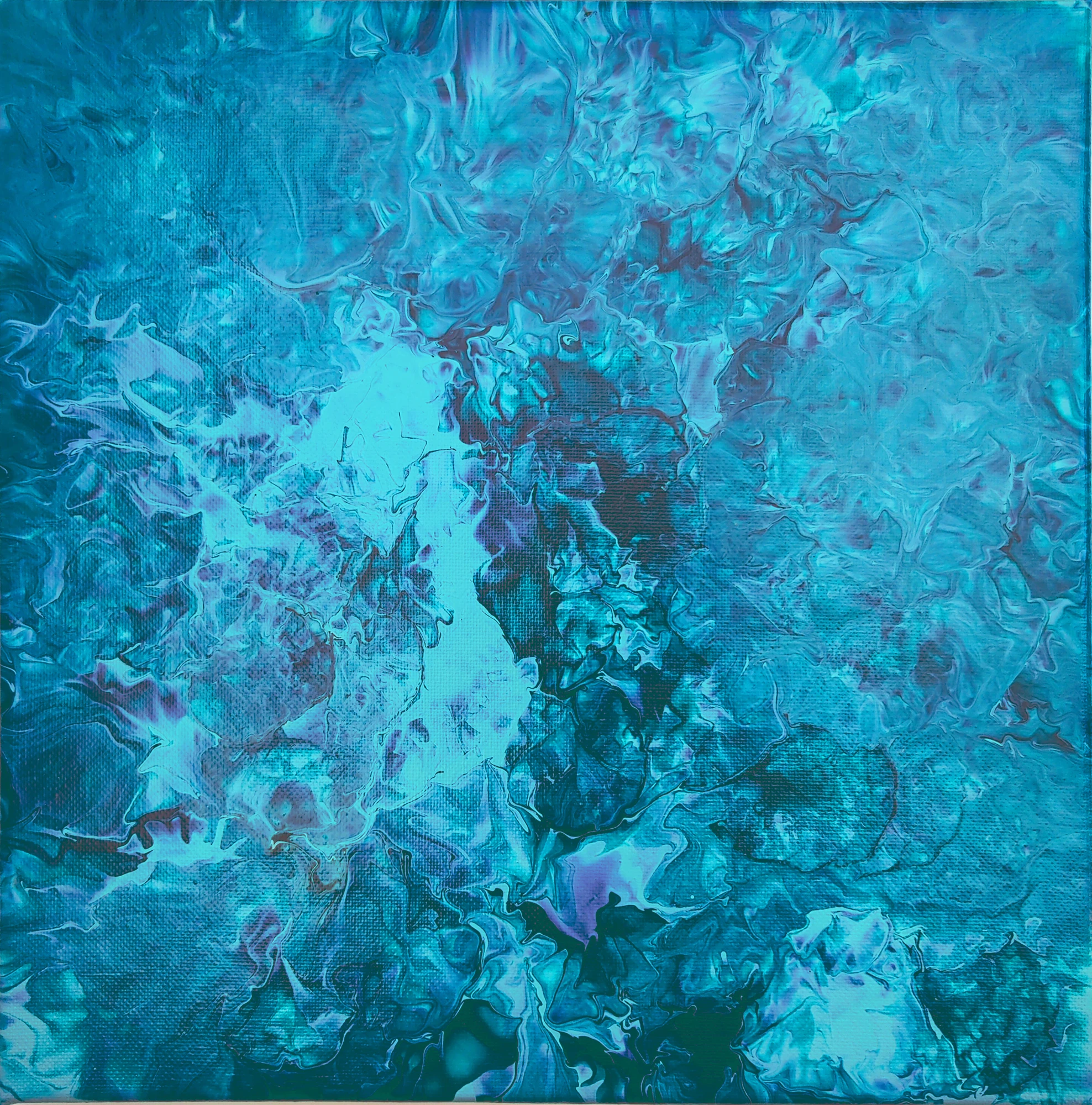 Blue and turquoise layers break into pale, branching forms.